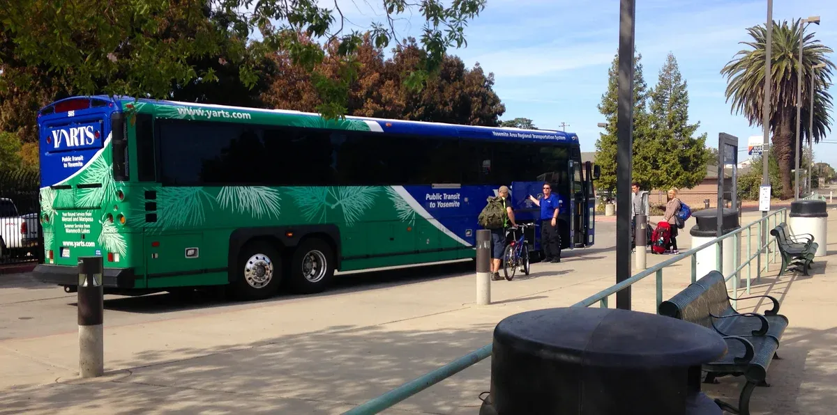 Passengers boarding a YARTS bus at the Merced Amtrak station on a Yosemite tour from San Francisco by train