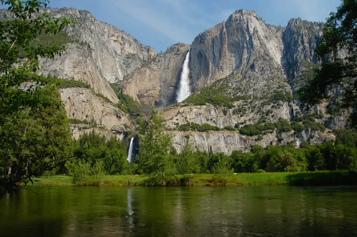 Upper and Lower Yosemite Falls flowing above the valley meadow on a Yosemite tour from San Francisco, California